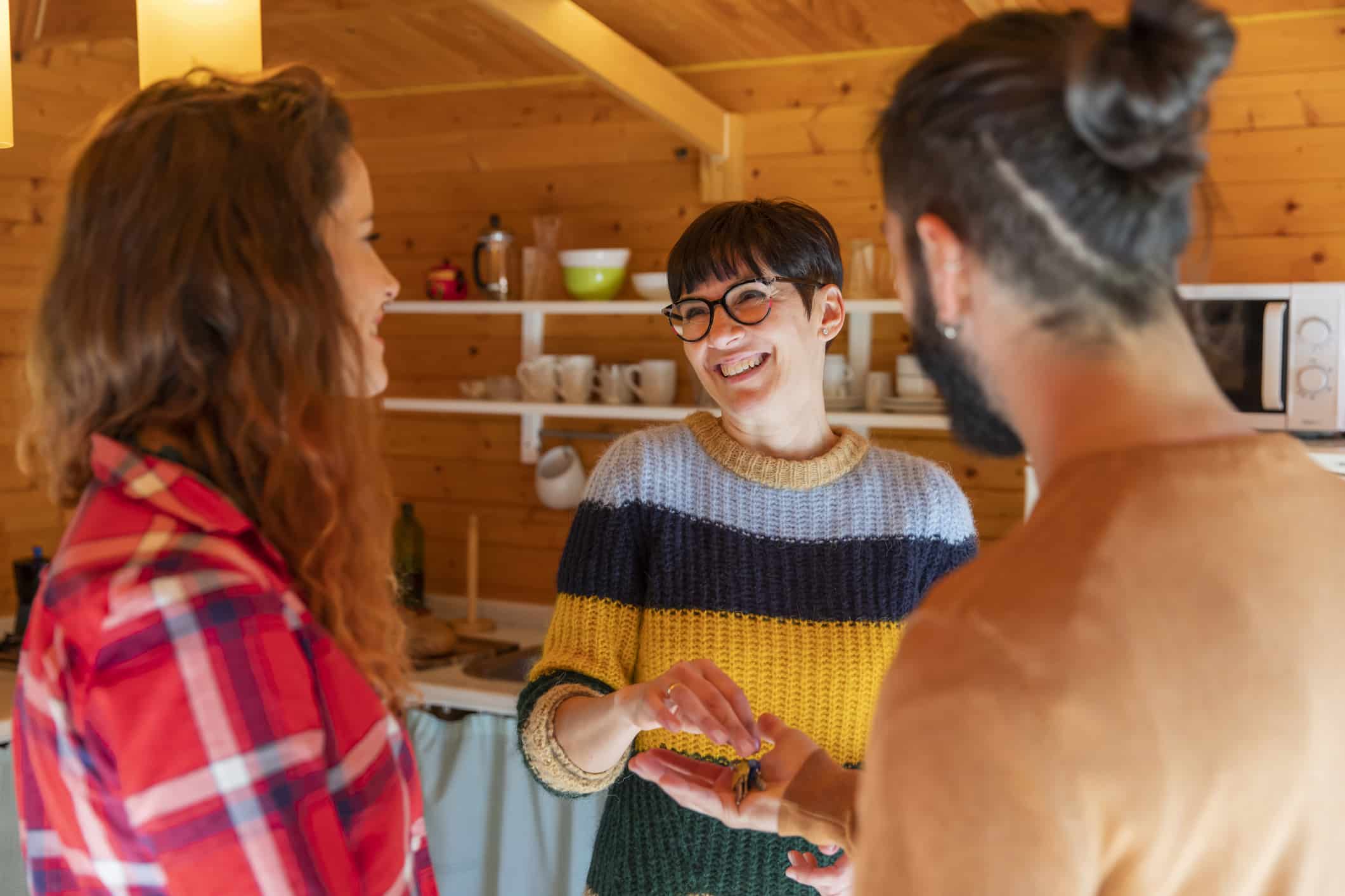 German landlord welcoming a young couple in a rental property. A blog about tax deductible expenses in Germany for rental property. 