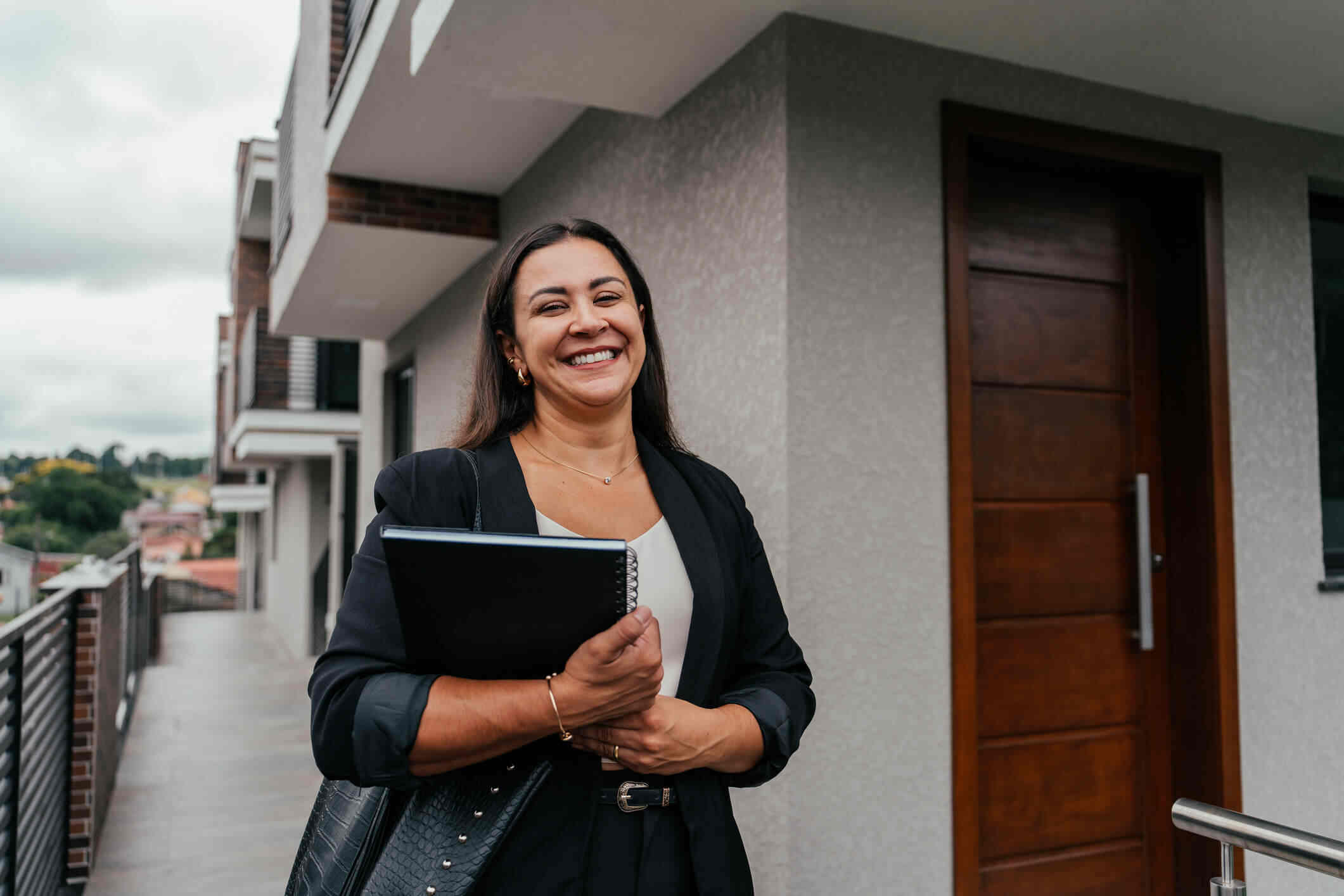 Professional Irish rent collection agent standing outside a residential property, representing services for non-resident landlords.